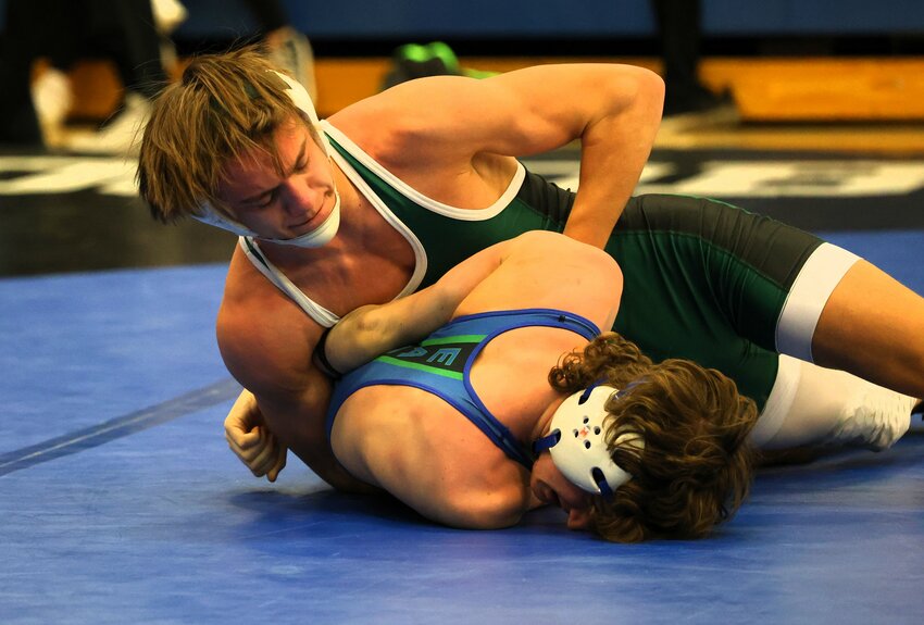 Layne Frandrup of the Wolfpack attempts to turn Eagan’s Ryder Besse at 139 pounds.