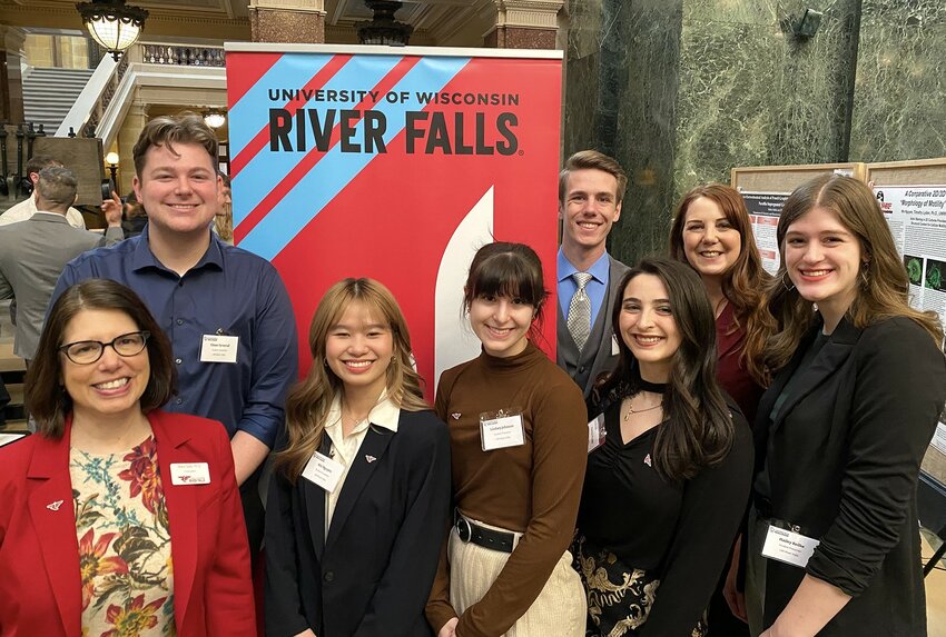 Six UW-River Falls students presented their research projects Wednesday at the state Capitol as part of the 20th annual Research in the Rotunda event that showcases undergraduate research by Universities of Wisconsin students. Pictured front row, left to right, are UW-River Falls Chancellor Maria Gallo, and students Nhi Nguyen, Lindsey Johnson, Katelyn Marano, and Hailey Beilke. Back row, left of sign is student Chase Syverud. Back row, right of sign are student Jordan Cioni and Molly Gerrish, who oversees UW-River Falls Research in the Rotunda students as director of the university&rsquo;s Undergraduate Research, Scholarly and Creative Activity program.
