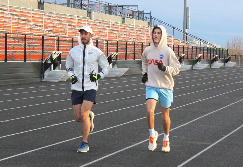Returning distance runner Lucas Walker (right) with Assistant  Coach Elliot Genteman at Henke Track Friday.