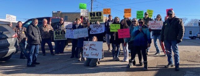 A group of concerned citizens protested outside of Ellsworth Village Hall on Thursday, March 28 prior to the Community Development Authority and special village board meetings.