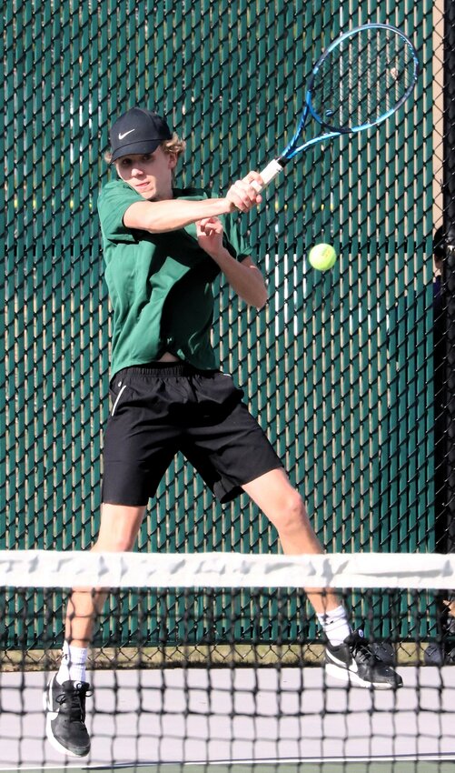 Caleb Swigart of the Wolfpack returns a volley at No. 1 singles.