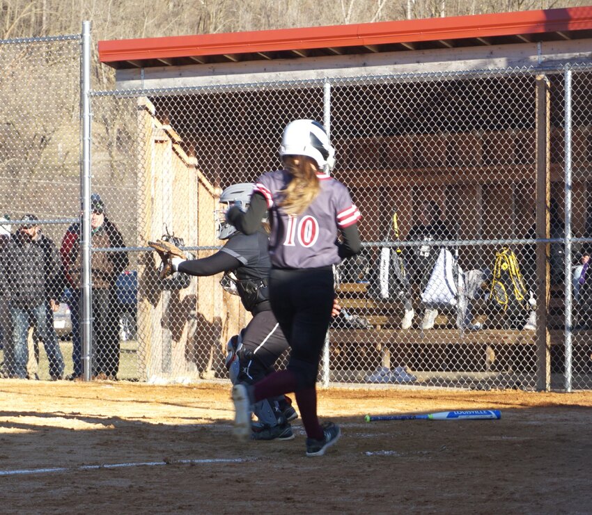Evah Butts comes in ahead of the play at the plate in the Cardinals&rsquo; 8-4 victory over the Wolves on Thursday in Spring Valley.