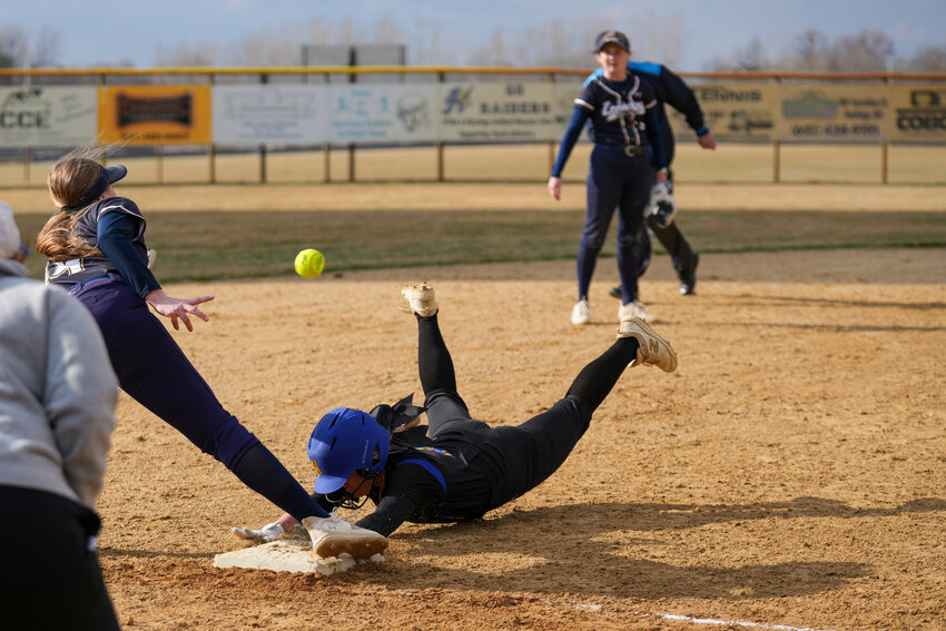 Emily Dembrowski dives headfirst into third base with excellent base running. The throw from the first baseman was wide, allowing Dembroski to score on an error giving Hastings their second run of the game in a four-run fifth inning.