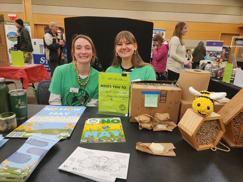 UW-River Falls Bee Club members Autumn Frederick (left) and Lucy Cahn staffed their club booth Saturday, April 20 during Earth Fest in the University Center. They handed out information on pollinator habitat and No Mow May.