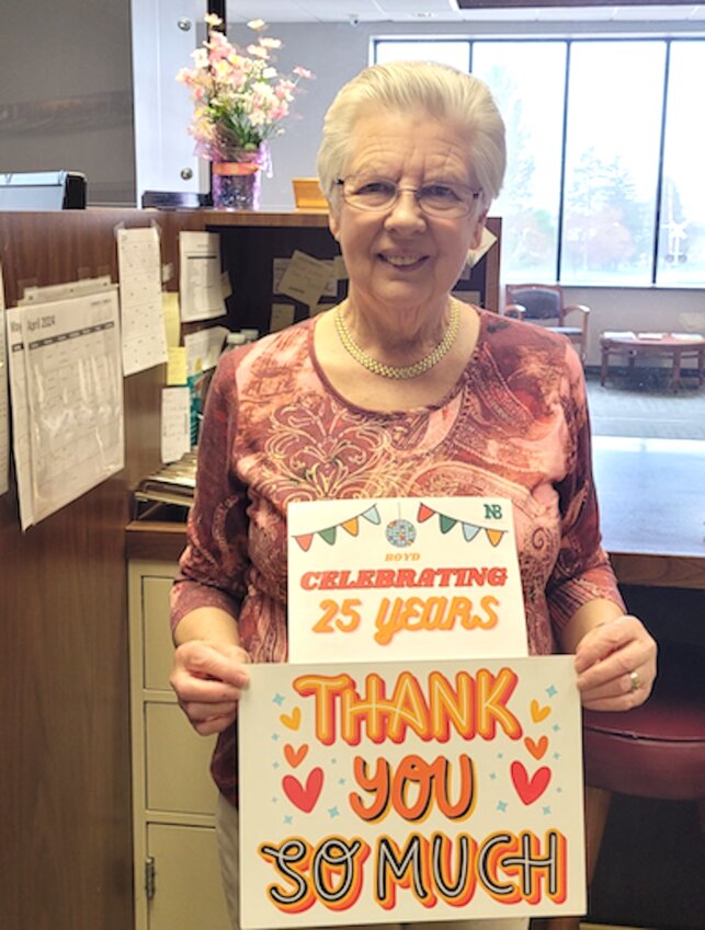 Toni Luzinski of Northwestern Bank holds a sign of customer appreciation.
