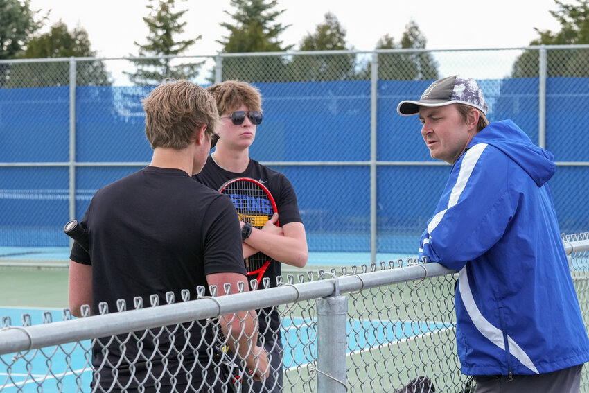 Head Coach Alex Zuzek chats with his second team doubles of Matt Darst and Nathan Welt, hoping to help them make adjustments between games. The second team doubles fell 6-2, 6-3 to Mahtomedi.