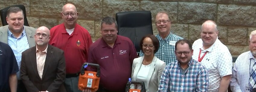 Members of Accacia Lodge #51 join the Cottage Grove City Council with donated fire suppression devices.