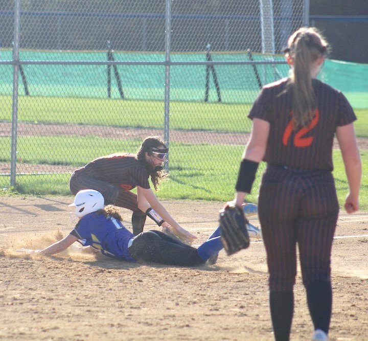 Kelly Lew tags a McDonell player at third base Friday as pitcher Ella Nitz looks on.