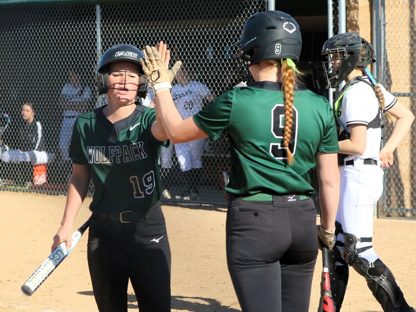 Park senior Grace Conaway gets a high five from teammate Ava Youngquist after a fifth-inning triple and a score against Roseville Friday.