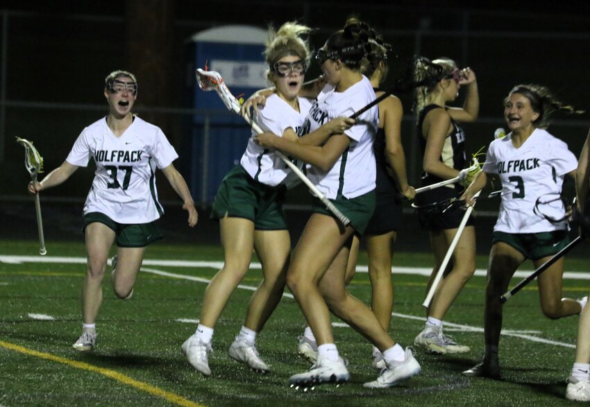 The Wolfpack rush to mob Sidni Gitzen after she scored the winning goal against visiting East Ridge Friday.