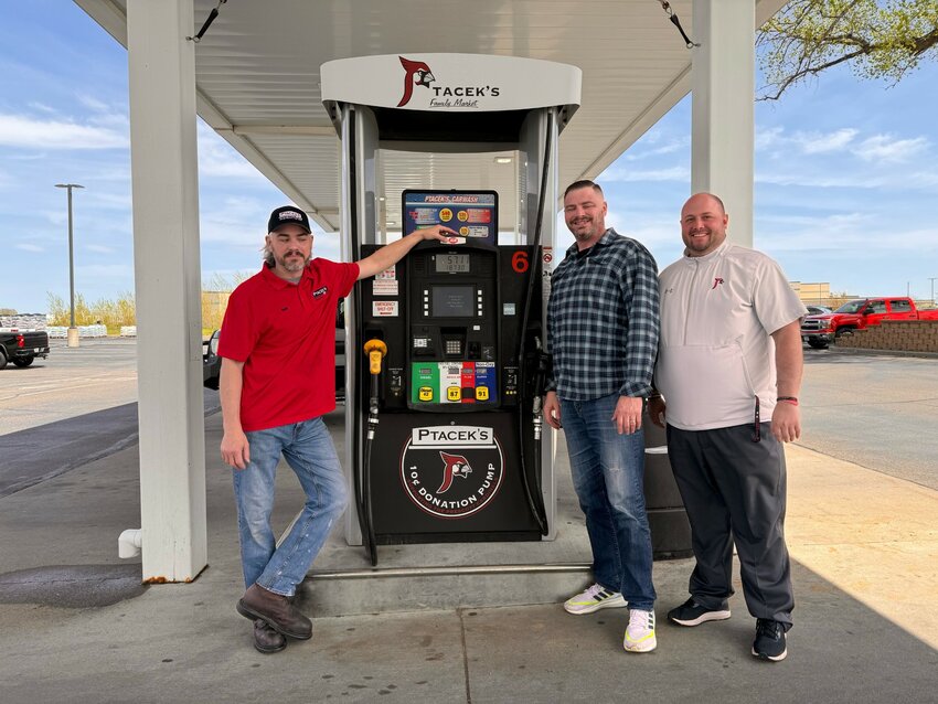 Raph and Pat Ptacek with Prescott School District Athletic Director Andrew Caudill at the Cardinal Pump at Ptaceks in Prescott.