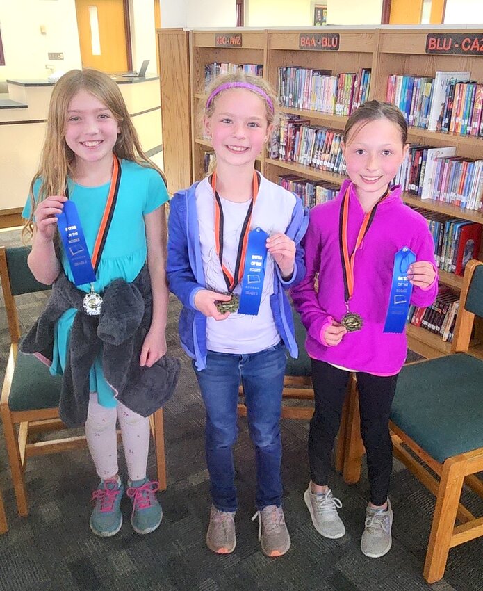 The “Reading Sisters” are the 3rd Grade Battle of the Books Competition Winners! After a nail-biting battle that resulted in many overtime questions, the Reading Sisters managed to sneak in with a win! From left:  Lydia Ogle, Cora Lilla, and Brea Savina.