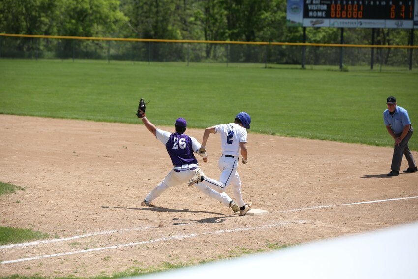 Power hitting first baseman Nolan Kummer stretches for the out in Saturday's home game against Saint Croix Central.