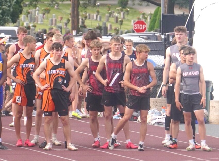 2-The Owen-Withee relay team waits just off the main track. From left: Vincent Henke, Dominic Sherwood, Brandon Geldernick, and Mason Gay.