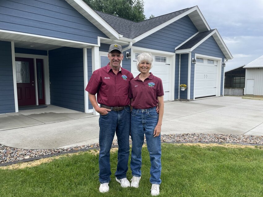 Randy and Lori Larson in front of their house at LoRan Rolling Acres.
