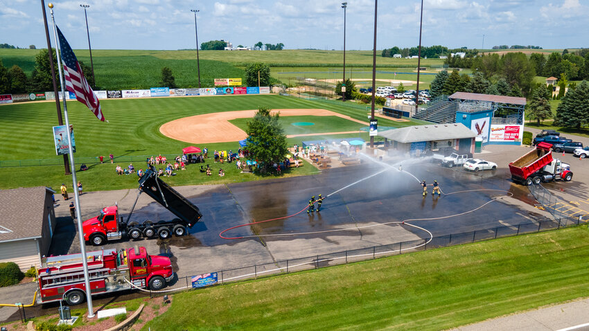 The Miesville Fire Department held their first annual Water Wars Saturday afternoon in their parking lot. Eight teams from around the region competed in this fun event. The goal is to push the empty keg that is suspended on the cable with via a pulley to the opponent’s end of the ‘arena’ using the water from the fire hose.