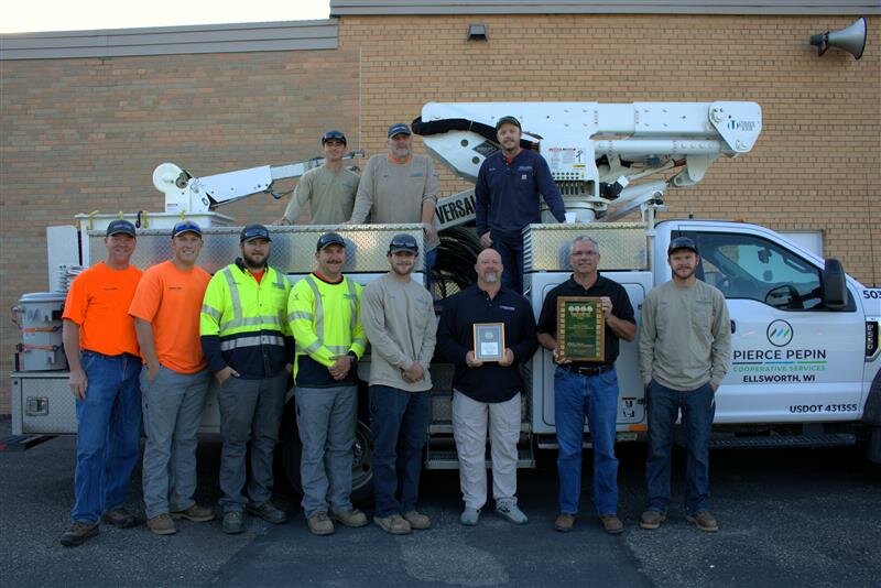Brad Ristow (second from right), PPCS vice president of operations, and Todd Olson, operations administrator, display the plaques PPCS received from the Arbor Day Foundation recognizing PPCS as a Tree Line USA utility for the 20th year in a row. The PPCS line crew pictured are (from left) Dan Jensen, Aaron Hanson, Brady Schommer, Tucker Ingenthron, Brent Paulson, Chase Reeser, (top) Jack Truttman, Brion Gilles, and Austin Manore.