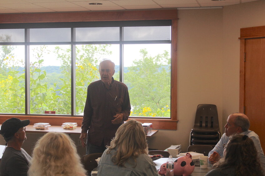 Cottage Grove farmer Gene Smallidge presents to the Prescott Community Club Aug. 1 at Freedom Park in Prescott. Smallidge was invited to present by a community club member after they asked the story behind a sign on the Smallidge Farm.