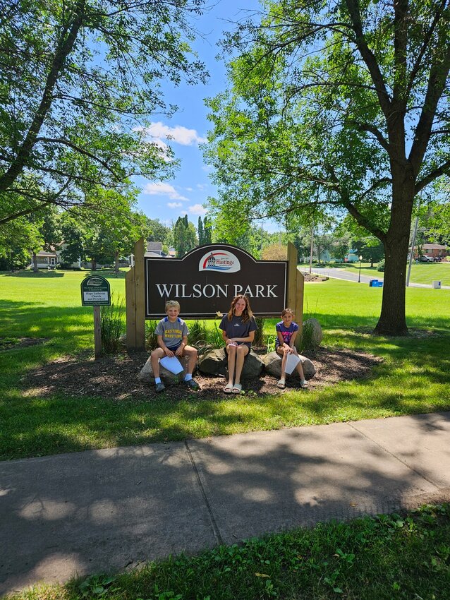 Lilah, Leo, and Harper in front of the Wilson Park sign.