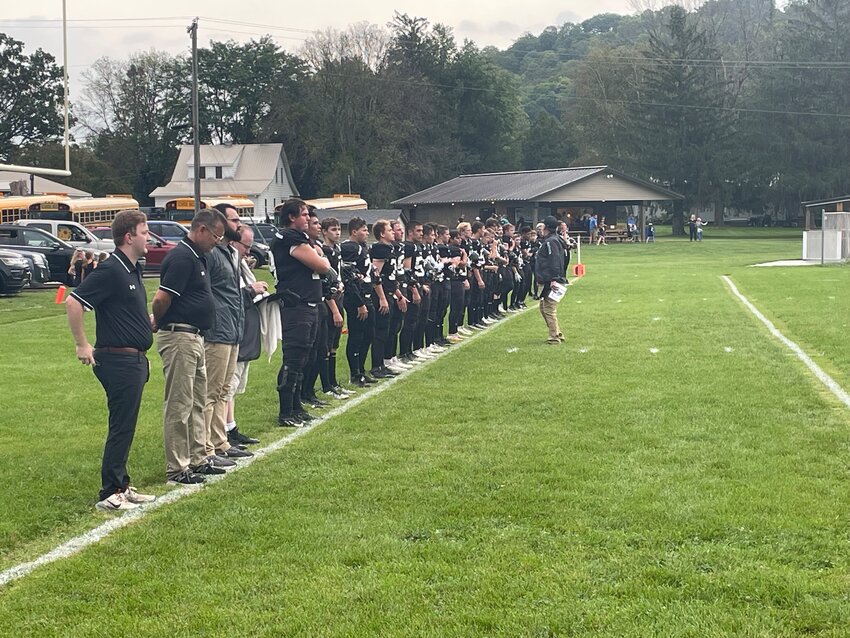 EPC players line up for the national anthem in a game that would quickly be postponed due to a storm.