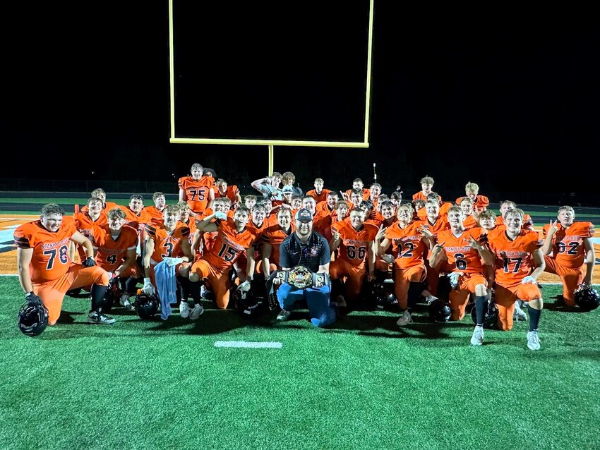 The team celebrates 100 wins with Robert Ferrier (center) as a team manager. Active wtih Stanley-Boyd football for over a decade, Ferrier is also involved in baseball.