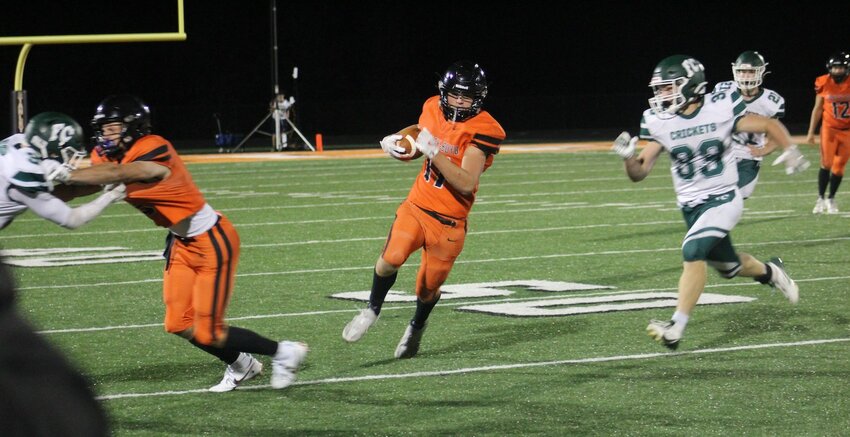 adden Mahr (left) holds off a Fall Creek player as Jake LaGrander carries the ball upfield.