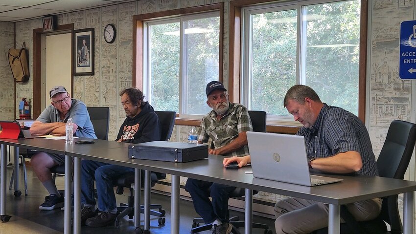 Henry Berry of Ratsch Engineering (right) reviews the sanitary permit for the new town hall with the Town of Thorp Board. From left: Chairman Louis Andruskiewicz, Supervisor Andy Slowiak and Supervisor Bob Kodl