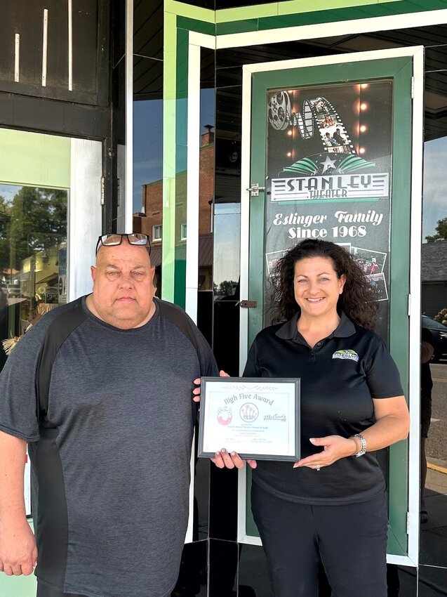 Louis Eslinger (left) and Theresa Pries accept the September High Five Award on behalf of the  Stanley Theater recently.