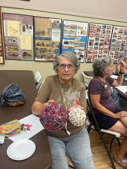 Jackie Robinson showing her handmade bowls.