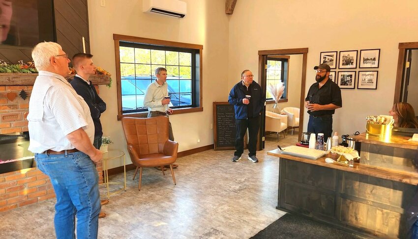 Local business owners enjoyed coffee and pastries while discussing the latest auto repair shop improvements. From left: Stanley Chamber President Ron Haas, financial planners Jack Syryczuk and Adam Smit, Chamber Board member Alex Zamarippa, and Todd and Misty Wundrow.