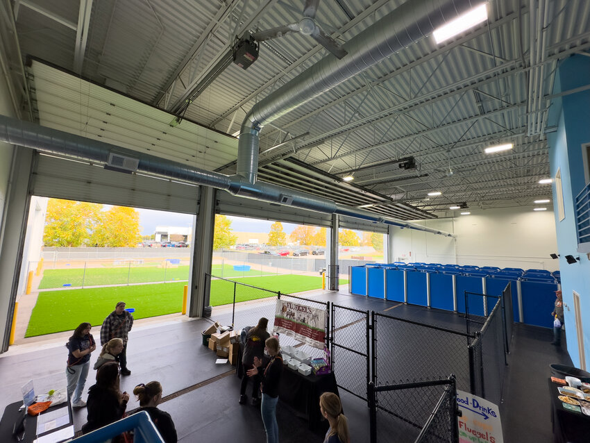 The folks at Barks & Rec did a great job laying out their new space in Hastings. The setup inside both sets of garages is very similar. There are several fenced in play spaces inside and out with the indoor space being climate controlled when needed. The space outside has turf and inside has heated rubber flooring that covers the play space and the kennels.