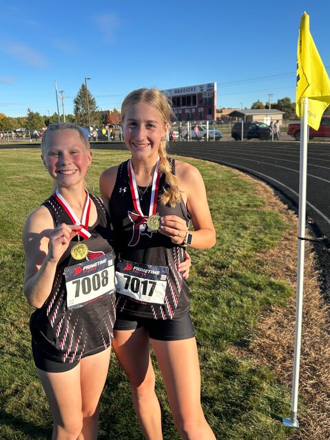 Sophomore Kyra Dix and junior Amber Van Loon after both medaling at the Amery Invitational on Oct. 8.