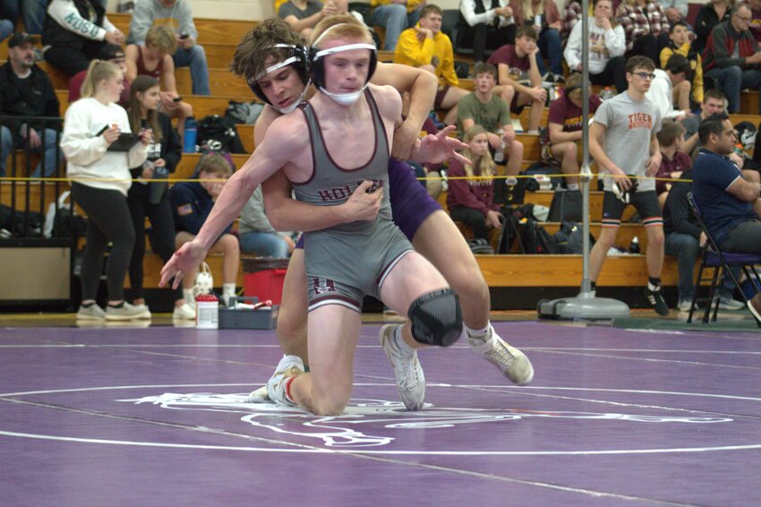 150-pound wrestler Knox Hines of Ellsworth attempts to hold off an escape in a first-round invitational matchup.