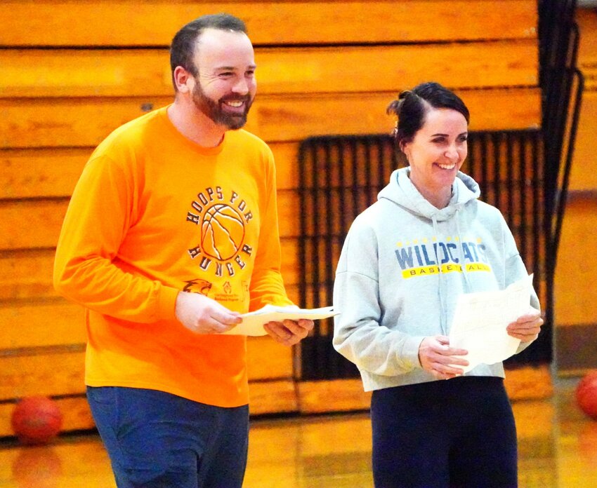 River Falls boys' basketball assistant coaches Eric Peters (left) and Lori Johnson (right) are enjoying a Wildcat warm-up exercise at practice this past week.