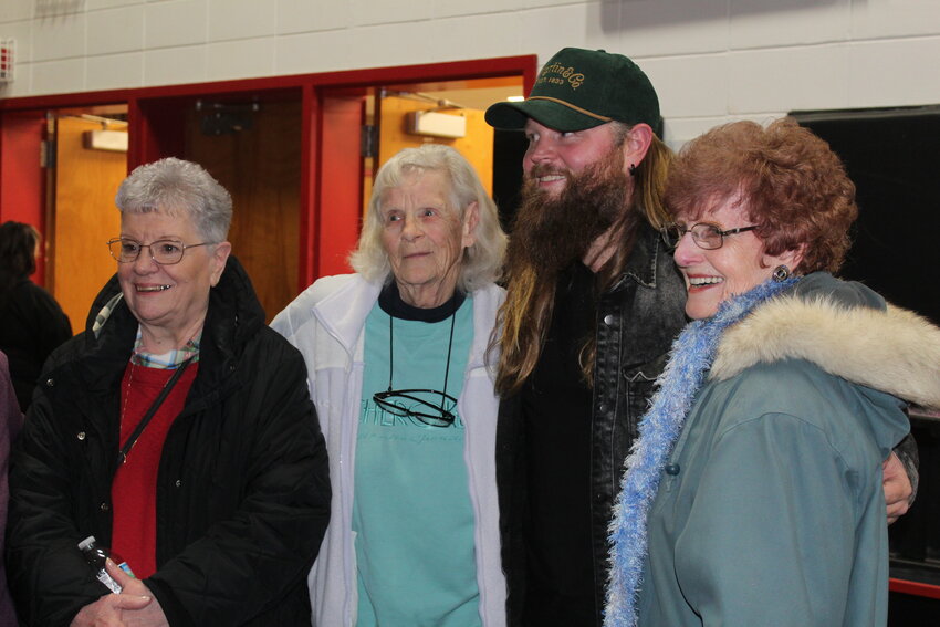 Sue Pries, Lola Venet and Lois Dehne grab a photo op with Chris Kroeze.