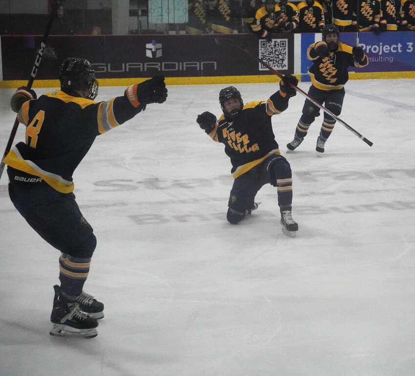 Wildcat junior Chase Rudolph (center) celebrates with a fist pump after his second period goal gave the Wildcats a 2-1 lead.