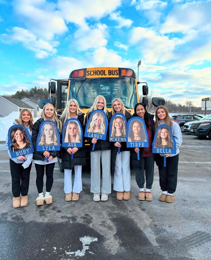 The River Falls gymnastics team loading up the bus for their trip to State at Wisconsin Rapids.