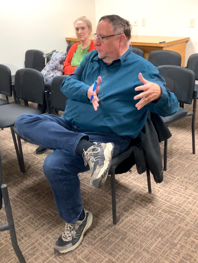 Library Director Elizabeth Miniatt listens to John Thompson, director of the IFLS library system, as he speaks March 6 at the special council meeting.