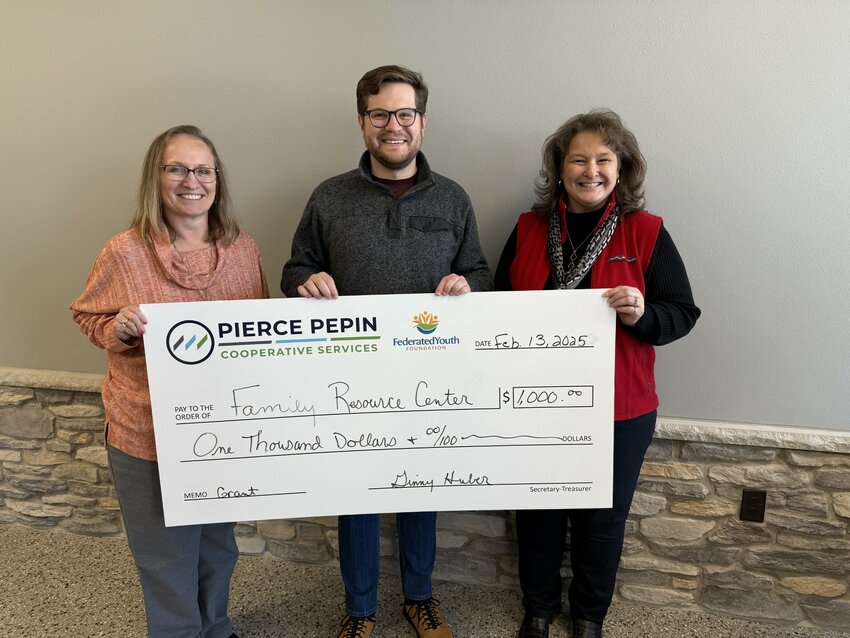 PPCS staff Becky Bradburn (left) and Barb Bee (right) presented Neil Kline of the Family Resource Center of St. Croix Valley with a $1,000 check to support their Special Events and Play &amp; Learn series.