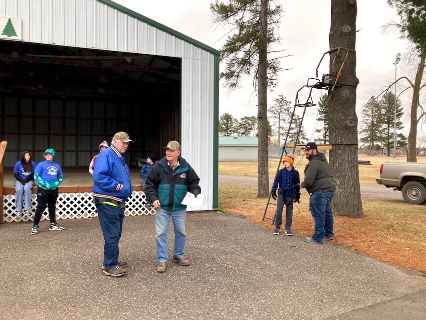 John Smoczyk shared about tree stand safety, aided by Joe Giwonja.