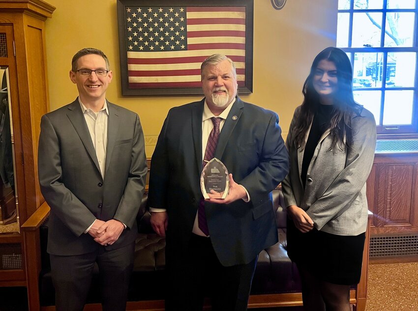 Sen. Rob Stafsholt (R-New Richmond) receives his award from PIA Executive Director Pete Hanson and Natalie White.