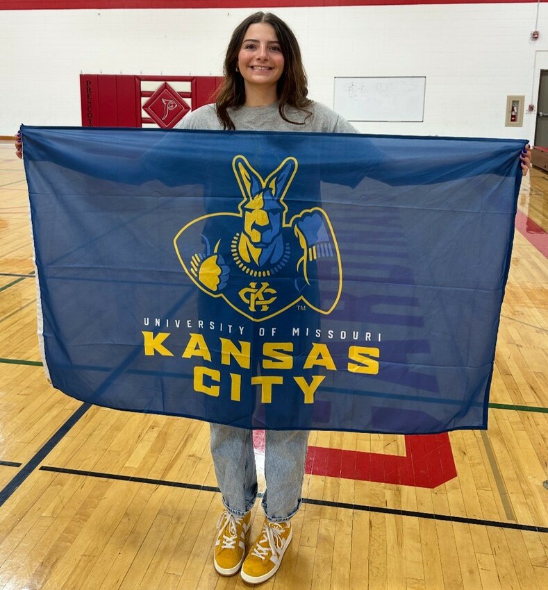 On Friday, May 2, Prescott High School senior Natalie Ptacek officially signed to play volleyball for the University of Missouri – Kansas City Kangaroos! She chose to hold her signing ceremony in the middle school gymnasium, with the 6-8 students in attendance, to demonstrate where hard work and determination can lead to. Pictured (from left) are: Sister Zoe, Natalie, and parents Joy and Patrick Ptacek.