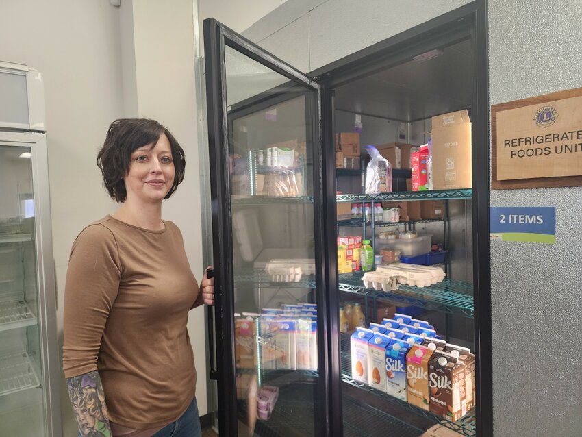 River Falls Community Food Pantry Executive Director Candice Anderson stands before the dairy case at the food pantry, which is noticeably sparse when it comes to eggs and milk.
