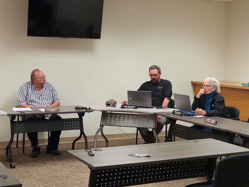 Alderpersons Terry Metzger (right) and Keith Samuelson, along with Mayor Mike Henke (left) approve a 12-foot easement for water and sewer lines to Paul Close at the Tuesday evening meeting.