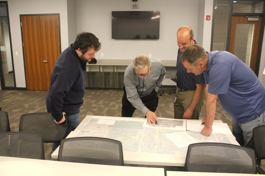 An open house on the raw water main project was held Thursday, May 1 at the HERO Center. Shown (from left) are Trevor Lotzke of SEH Engineering, city resident Kevin Oppold, Cottage Grove Public Works Director Ryan Burfeind, and Jeff Then of SEH Engineering.