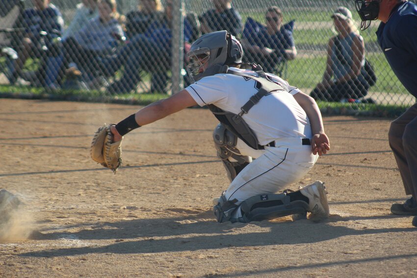 Sophomore catcher Logan Auth snatches a pitch behind the plate.