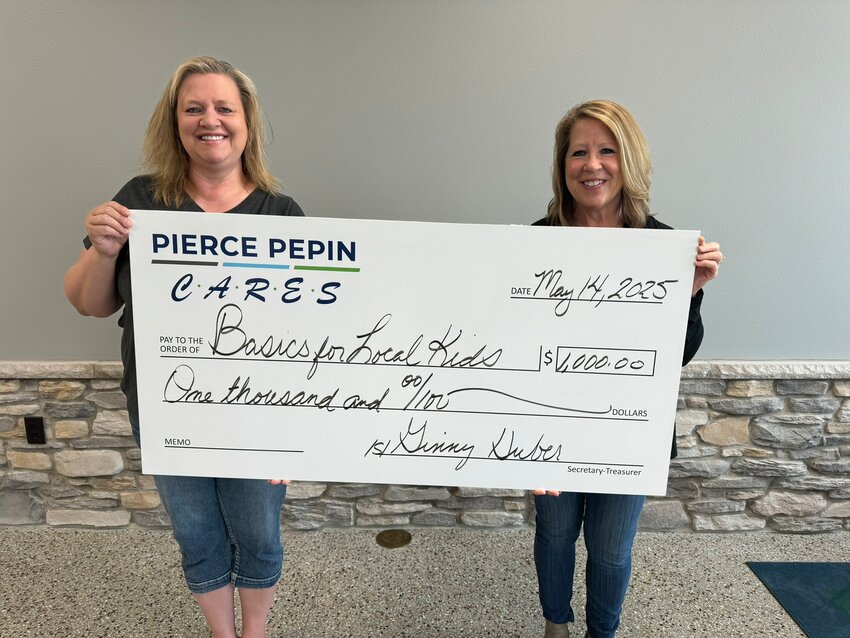 Kim Johnson (left) of Basics for Local Kids received a $1,000 check presented by Donna Taranto (right), PPCS member relations representative, to support their mission of providing winter clothing to children.