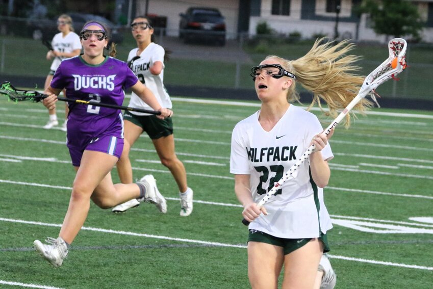 Maleah McMorrow (22) of the Wolfpack brings the ball up field in a hurry.