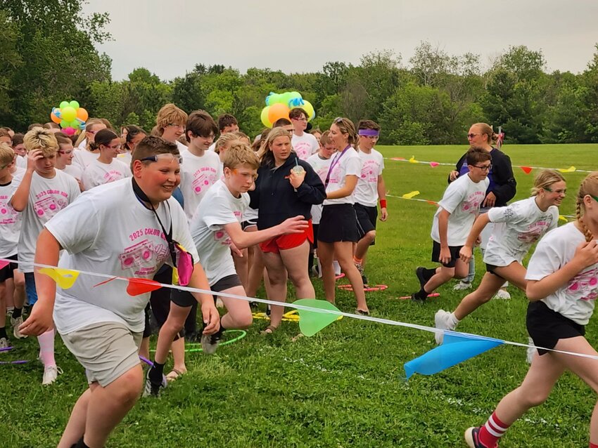 Ellsworth Middle School Principal Olin Morrison was a willing participant in the EMS Color Run May 30. He takes off from the finish line with students.
