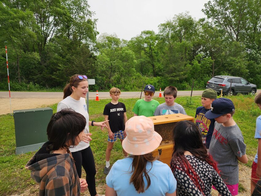 River Falls junior Morgan Matheson teaches Westside Elementary students about beekeeping at the Elementary Ag Day held Friday, May 30 at the school district property off Dry Run Road.
